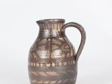 an image of a brown vase sitting on top of a white surface