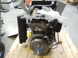 a small engine on a wooden table in a workshop