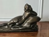a bronze statue of a man and a dog on a table