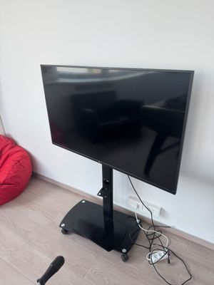 a flat screen tv sitting on a stand in the corner of a room