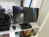 a computer monitor sitting on top of a white shelf