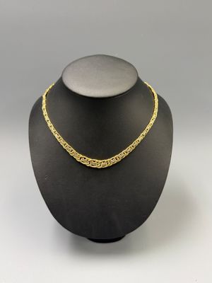 a black mannequin with a gold chain on top of it