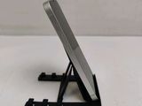 a cell phone sitting on a stand on a table