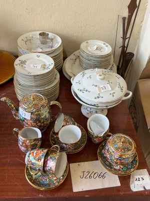 many plates and cups on a table with a price tag