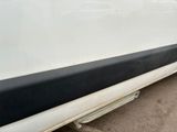 a close up of a white car with a black stripe