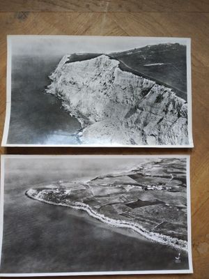 two old black and white photos of an island in the ocean