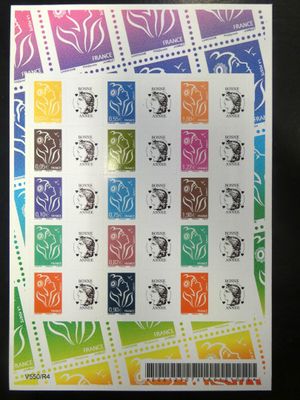 a close up of a sheet of stamps with different designs on them