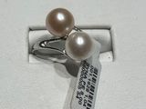 a ring with a pearl and a tag on it