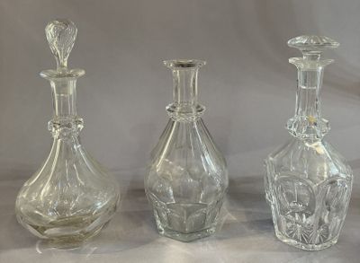 three clear glass bottles sitting next to each other on a table