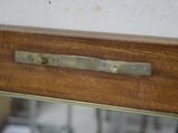 a close up of a mirror with a metal handle