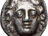 a close up of a coin with a face on it