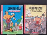 two children ' s books sitting on a table with a black background