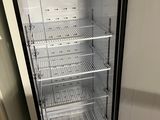 an empty refrigerator with a door open in a kitchen
