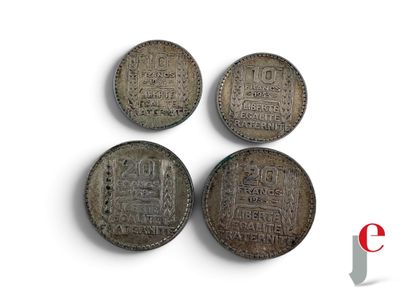 three old chinese coins sitting next to each other on a white surface