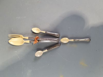 several spoons and forks are arranged in a circle on a table