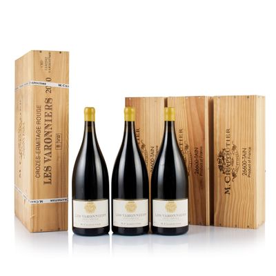 three bottles of wine in a wooden box next to a wooden box