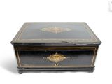 a small black box with gold decoration on it