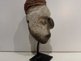 sculpture of a man ' s head with a leather band around his neck