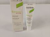 a close up of a tube of exfoliac cream next to a tube of exfoliac cream