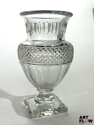 a glass vase that is sitting on top of a table