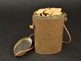 a metal container with a metal lid and a metal spoon in it