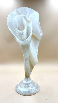 a white flower that is sitting on top of a table