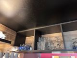 a shelf with glasses and cups on it in the kitchen