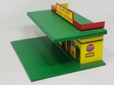 a green shelf with a yellow box and a red box on it