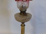 a glass vase with flowers in it sitting on a table