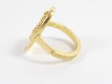 a close up of a gold ring on a white surface