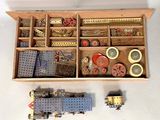 a wooden box filled with different types of sewing supplies