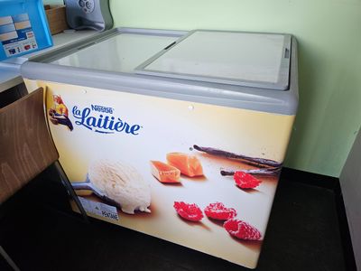 a small ice cream machine sitting in a kitchen