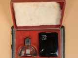 a small box with a bottle of perfume inside of it