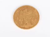 a gold coin on a white surface with a white background