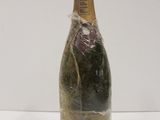 a close up of a bottle of champagne on a white surface