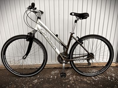 a bike parked against a wall in front of a building