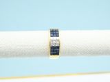 a gold ring with a blue sapphire stone set in it