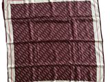 a red and white square scarf with a pattern on it