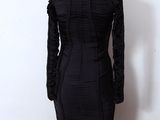the dress is black and has long sleeves on it