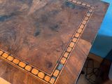 a wooden table with a decorative design on the top of it