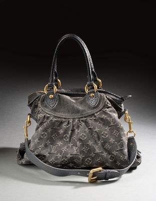 a close up of a louis vuitton bag on a white surface
