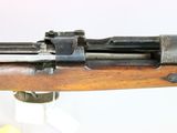 an old rifle with a wooden barrel and a metal handle