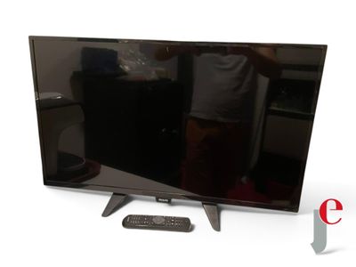 a man standing in front of a flat screen tv