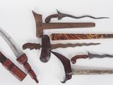 many different types of knives on a white surface