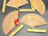 six chinese fans and a box of matches on a table