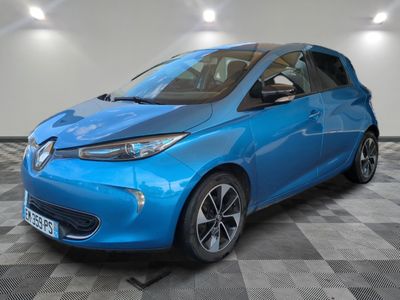a blue car is parked in a room with a checkered floor