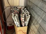 a cardboard box full of rolled up newspapers in front of a door