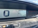 a close up of a car ' s dashboard with a check button