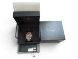 a box with a watch inside of it on a white surface