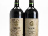 two bottles of wine sitting next to each other on a table